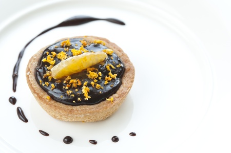 Mini chocolate tart with tangerine and orange zest topping