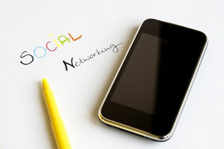 Social Networking Concept with colorful letters, modern touch screen mobile phone and yellow highlighterの写真素材