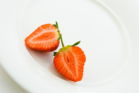 Fresh strawberries on white plateの写真素材