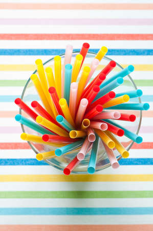 Colorful drinking straws in a glass from above