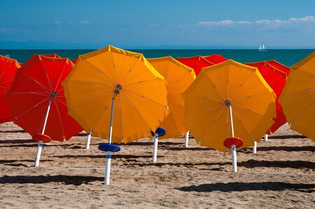 Colorful umbrellas on sandy beach in Lignano Sabbiadoro, Italy, Europeの写真素材