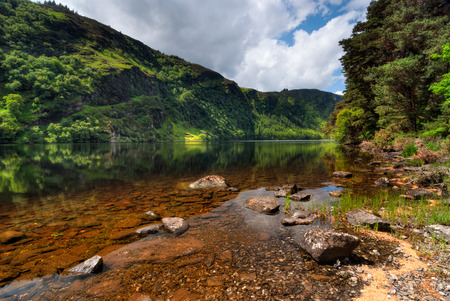 Sunny morning over Upper Lake in Glendalough Scenic Park Co. Wicklow Irelandの写真素材