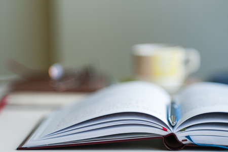 Close up of open notebook blurred with very shallow depth of field