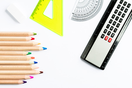 Set of school accessories with calculator on white background top view