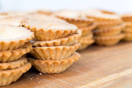 Close up of homemade empty mini tartlets on wooden tableの写真素材