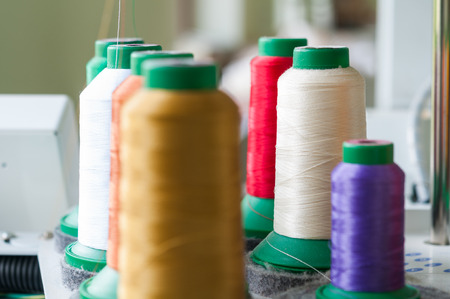 Sewing threads multicolored background closeup with shallow depth of field