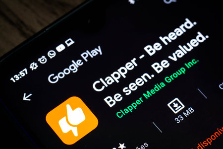 February 2, 2021, Brazil. In this photo illustration the Clapper logo seen in the background of a silhouette hand holding a mobile phoneのeditorial素材