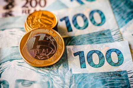 In this photo illustration being displayed fifty, one hundred and two hundred reais bills and a one...