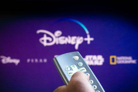 June 3, 2021, Brazil. In this photo illustration a person holds the TV remote control and in the...
