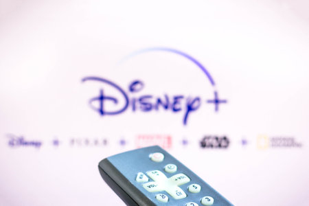 June 3, 2021, Brazil. In this photo illustration a person holds the TV remote control and in the...