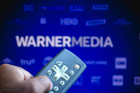 June 3, 2021, Brazil. In this photo illustration a person holds the TV remote control and in the...