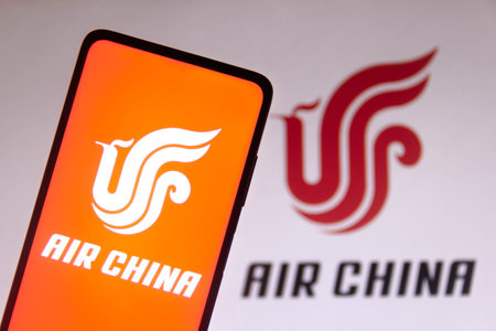 November 10, 2021, Brazil. In this photo illustration the Air China logo is displayed on a smartphone screen and in the backgroundのeditorial素材