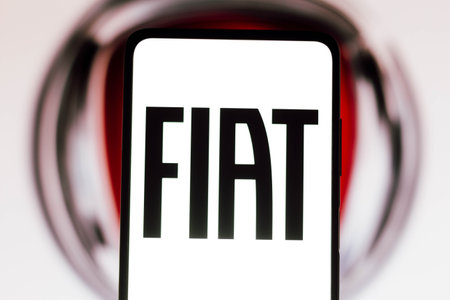 November 9, 2021, Brazil. In this photo illustration FIAT logo is seen on a smartphone screen and in...
