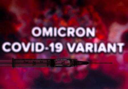 November 29, 2021, Brazil. In this photo illustration medical syringes are seen displayed in front of the words the micron covid-19 variant displayed on a screenのeditorial素材