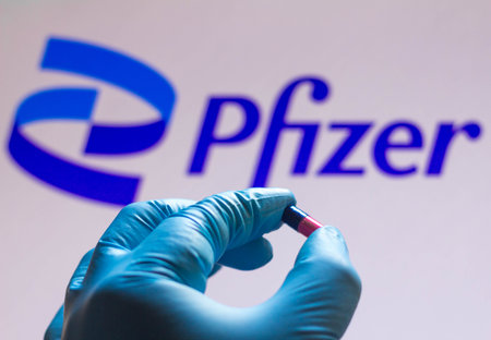 November 26, 2021, Brazil. In this photo illustration Merck Sharp & Dohme (MSD) logo is seen on a screen and a hand holding a pillのeditorial素材