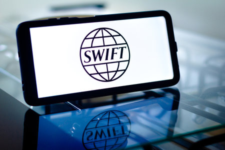 February 28, 2022, Brazil. In this photo illustration, a Society for Worldwide Interbank Financial Telecommunication (SWIFT) seen displayed on a computer screen through a magnifying glassのeditorial素材