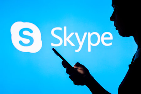 March 28, 2022, Brazil. In this photo illustration, a woman's silhouette holds a smartphone with the Discord logo displayed on the screen and in the backgroundのeditorial素材