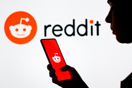 March 28, 2022, Brazil. In this photo illustration, a woman's silhouette holds a smartphone with the Discord logo displayed on the screen and in the backgroundのeditorial素材