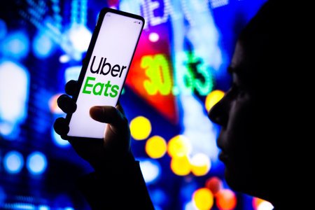 April 1, 2022, Brazil. In this photo illustration, a woman's silhouette holds a smartphone with the Gojek displayed on the screenのeditorial素材
