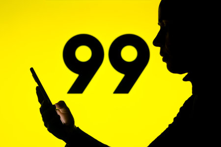 April 1, 2022, Brazil. In this photo illustration, a woman's silhouette holds a smartphone with the Gojek displayed on the screenのeditorial素材