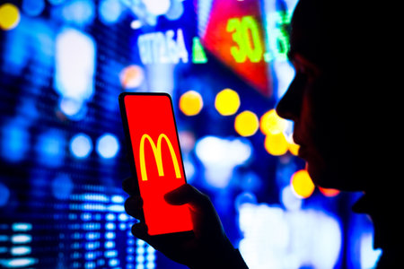 April 1, 2022, Brazil. In this photo illustration, a woman's silhouette holds a smartphone with the Gojek displayed on the screenのeditorial素材