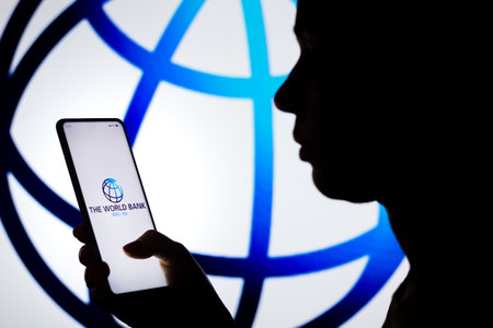 April 6, 2022, Brazil. In this photo illustration, a woman's silhouette holds a smartphone with the Credit Karma displayed on the screenのeditorial素材