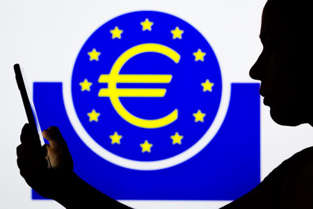 April 6, 2022, Brazil. In this photo illustration, a woman's silhouette holds a smartphone with the Credit Karma displayed on the screenのeditorial素材