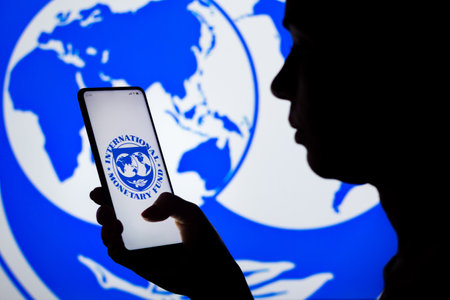 April 6, 2022, Brazil. In this photo illustration, a woman's silhouette holds a smartphone with the...