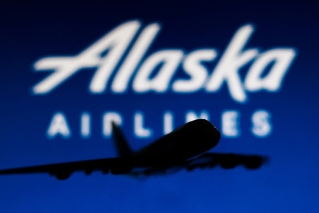 May 25, 2022, Brazil. In this photo illustration the Alaska Airlines logo seen in the background of a silhouette of an Airbus A380 planeのeditorial素材