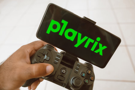 August 11, 2023, Brazil. In this photo illustration, a person plays on a joystick and the Playrix...