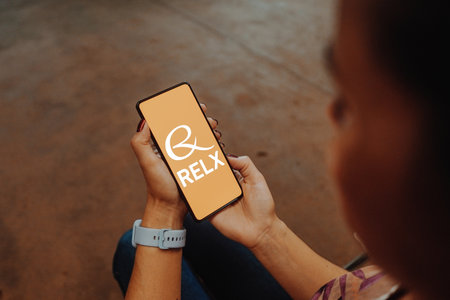 December 20, 2023, Brazil. In this photo illustration, the RELX Group logo is displayed on a smartphone screenのeditorial素材