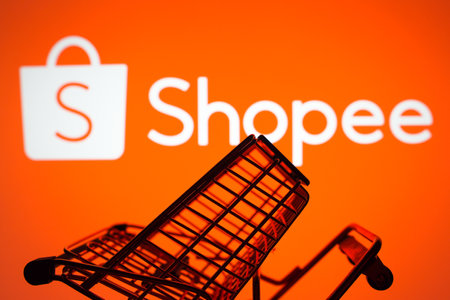 March 26, 2024, Brazil. In this photo illustration, the Shopee logo seen displayed on a smartphone along with a shopping cartのeditorial素材