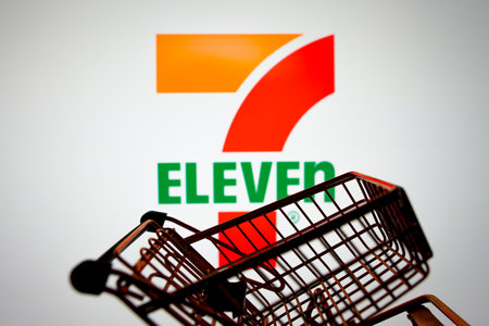 March 31, 2024, Brazil. In this photo illustration, the 7-Eleven logo seen displayed on a smartphone along with a shopping cartのeditorial素材