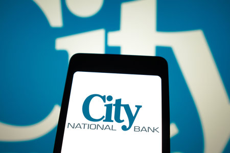 April 9, 2024, Brazil. In this photo illustration, the City National Bank logo is displayed on a smartphone screen and in the backgroundのeditorial素材