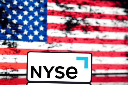 May 6, 2024, Brazil. In this photo illustration the New York Stock Exchange (NYSE) logo is displayed on a smartphone screen and in the background, the United States flagのeditorial素材
