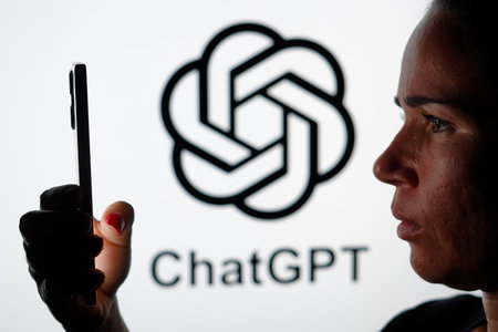 May 15, 2024, Brazil. In this photo illustration, the woman holding a smartphone and the ChatGPT...
