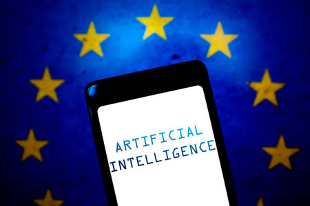 May 21, 2024, Brazil. In this photo illustration, the Artificial Intelligence (AI) text is displayed on a smartphone screen and in the background, the flag of the European Union. The EU Council said it has approved the AI ââLaw â a groundbreaking reのeditorial素材
