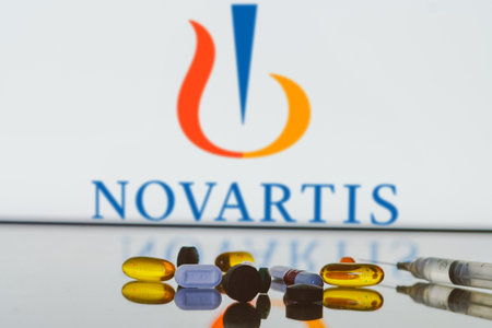 May 27, 2024, Brazil. In this photo illustration, the Novartis logo is displayed on screen in the background with pills and medical bottle and syringeのeditorial素材