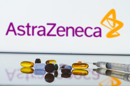 May 27, 2024, Brazil. In this photo illustration, the AstraZeneca logo is displayed on screen in the background with pills and medical bottle and syringeのeditorial素材
