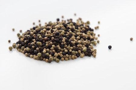 Three colors pepper scattered on white tableの写真素材