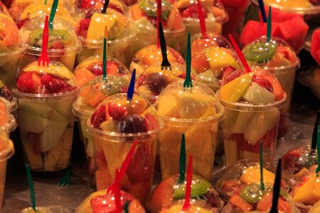 Glasses full of fresh fruit, stand in La Boqueria market, an old traditional market in Barcelona, famous landmark.の写真素材
