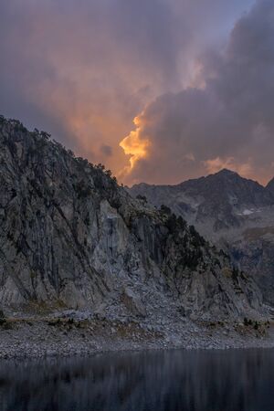 Sunset with clouds on Lake Cap de Longの写真素材