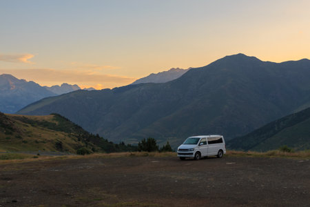 White van parked in parking lot between mountainsの写真素材