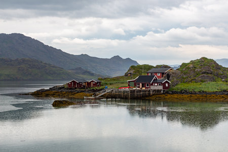 House with wooden jetty on the shore of the lake
