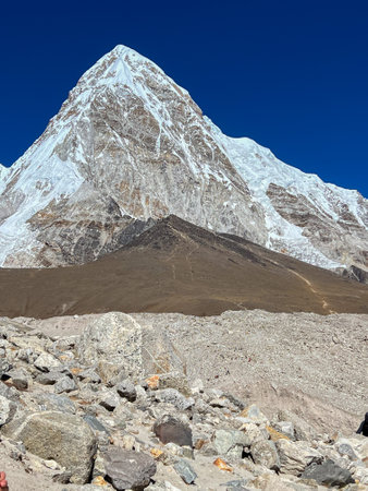 Nepali brown mountain with high snowy mountain in the backgroundの写真素材