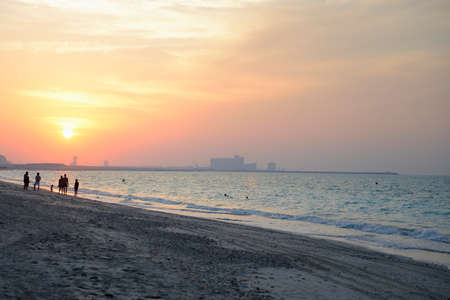 people walking on the beachの写真素材