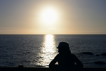 Woman silhouette and sunの写真素材