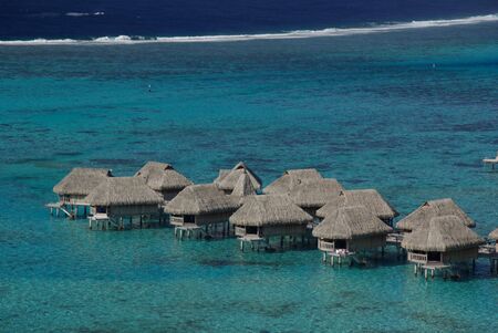 Luxury resort hotel on a blue and turquoise lagoon in Tahitiの写真素材