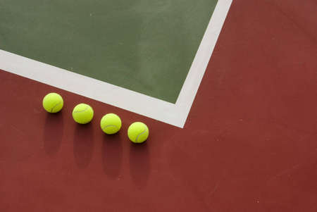 Four tennis balls on the court.の写真素材
