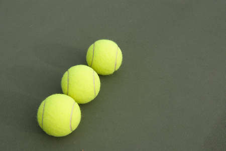 Three tennis ball on the courtの写真素材